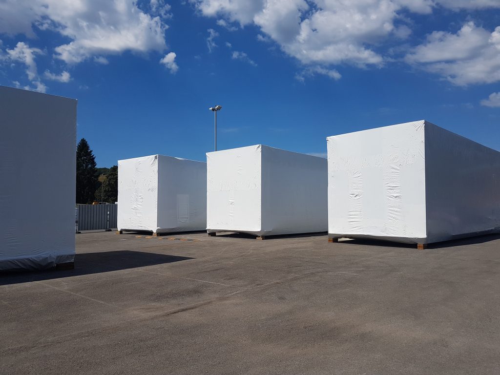 Protecting modular units with Tufcoat shrink-wrap solutions. Modular building cover